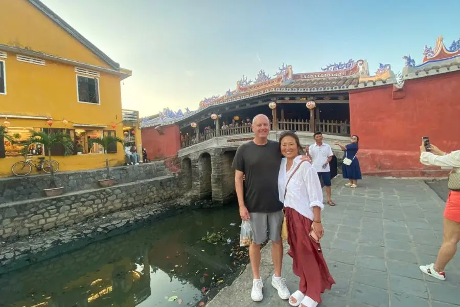 Tourists walking near ancient temple courtyard in Hoi An as part of danang tours experience