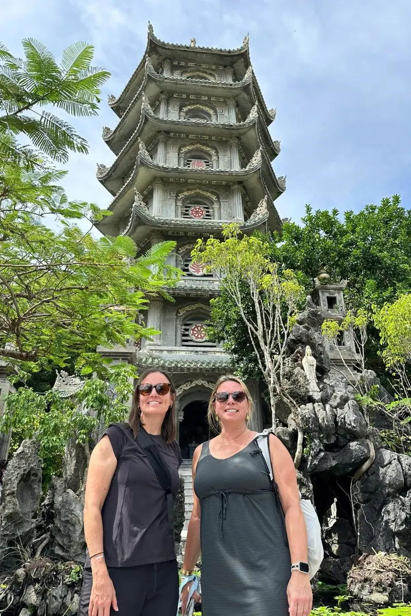 Visitors standing in front of Linh Ung Pagoda tower on a sightseeing stop in danang tours