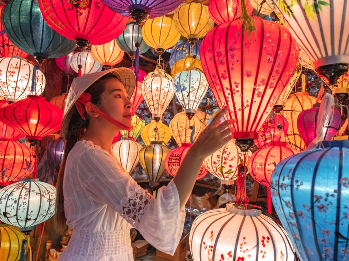 a woman taking photo with lanterns